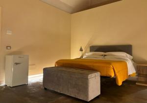 a bedroom with a bed with an ottoman next to it at Suite di Bianca in Foligno