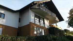 a house with a balcony on top of it at Fewo Schwarz in Ettenheim