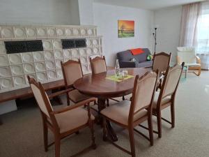 a dining room with a table and chairs and a couch at Fewo Schwarz in Ettenheim +5 photos