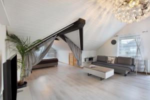 a living room with a couch and a table at Schwarzwaldglück Loft in St. Blasien