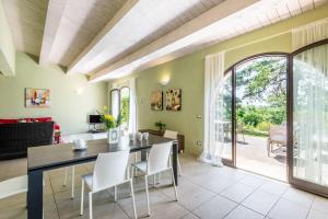 a dining room with a table and chairs and a living room at Villa Salvia in Trequanda