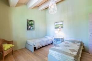 a bedroom with two beds and a table and a lamp at Villa Salvia in Trequanda +37 photos