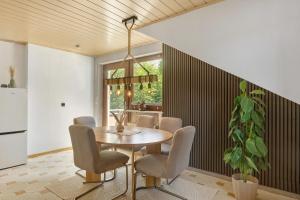 a dining room with a table and chairs at Wohung zum Ausblick in Plettenberg