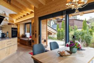 a kitchen and dining room with a table and chairs at Alpenchalet 19 in Krün