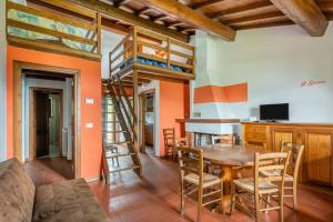 a dining room with a table and a bunk bed at Il Serrino 4 in Pistoia