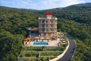an aerial view of a hotel with a sign on top of it at EDEM free parking, sea view & pool in Kunje