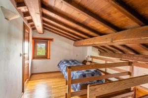 a bedroom with a bunk bed and wooden ceilings at Il Serrino 4 in Pistoia +31 photos