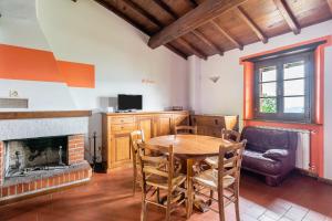 a dining room with a table and a fireplace at Il Serrino 4 in Pistoia