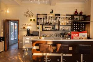a kitchen with a counter and a bar with stools at EDEM free parking, sea view & pool in Kunje