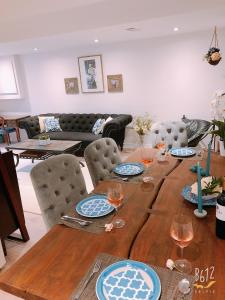 a wooden table with plates and wine glasses on it at Cozy 2bedroom Basement unit in Toronto +25 photos