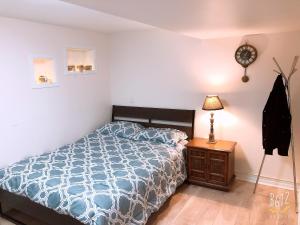 a bedroom with a bed and a clock on the wall at Cozy 2bedroom Basement unit in Toronto