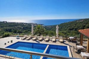 a villa with a swimming pool and a view of the ocean at EDEM free parking, sea view & pool in Kunje