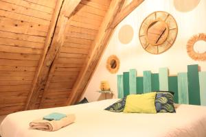 a bedroom with a bed in a room with wooden walls at Gite La Grange De Loey in Méallet