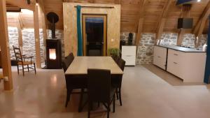 a kitchen and dining room with a table and chairs at Gite La Grange De Loey in Méallet