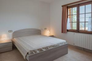 a bedroom with a bed and a window at Casa Terra de Chispa by Easy Brava in Calonge +13 photos