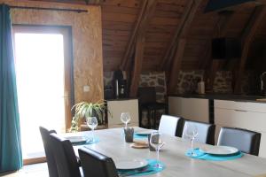 a dining room with a table and chairs at Gite La Grange De Loey in Méallet