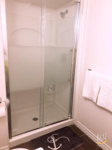 a shower with a glass door in a bathroom at Cozy 2bedroom Basement unit in Toronto