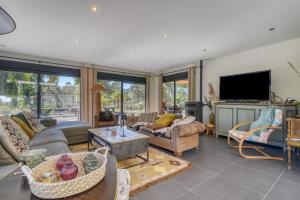 a living room filled with furniture and a flat screen tv at Awa Natura in Aigues