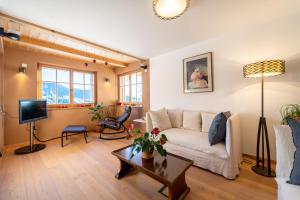 a living room with a white couch and a table at Lexn Radein in Redagno