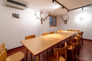 a row of tables and chairs in a room at Lexn Radein in Redagno