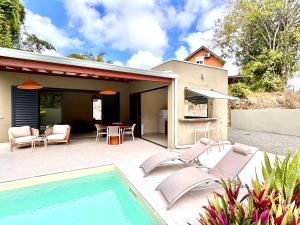 a patio with chairs and a swimming pool at CASA M Peaceful haven with pool in Îlet à Christophe