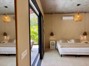 a bedroom with two beds and a window at CASA M Peaceful haven with pool in Îlet à Christophe