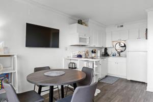 a kitchen and dining room with a table and chairs at Boardwalk Breeze Oceanfront Pool Villa in Carolina Beach +32 photos