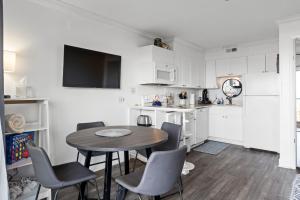 a kitchen with a table and chairs in a room at Boardwalk Breeze Oceanfront Pool Villa in Carolina Beach