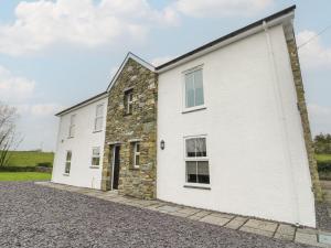 an exterior view of a white building at Chapel House in Llantrisant