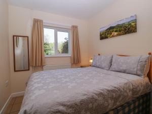 a bedroom with a bed and a window at The Turbles - Wagtail in Castlemorton