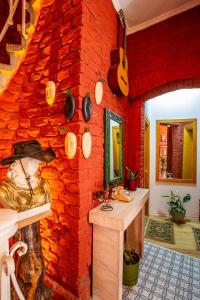 a room with a red brick wall with pots and pans at 1826 Heritage House in Taksim