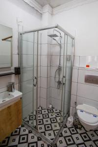 a bathroom with a shower and a toilet and a sink at 1826 Heritage House in Taksim