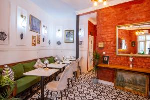 a restaurant with tables and a green couch at 1826 Heritage House in Taksim