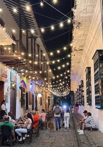 a group of people sitting in an alley with lights at Alojamiento Santa Fe de Antioquia in Santa Fe de Antioquia