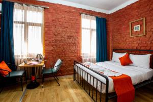 a bedroom with a bed and a brick wall at 1826 Heritage House in Taksim +31 photos