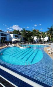 a large swimming pool with blue water at Alojamiento Santa Fe de Antioquia in Santa Fe de Antioquia +14 photos