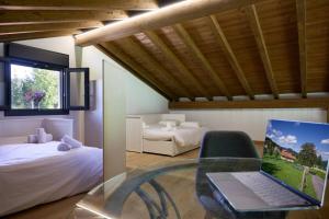 a bedroom with a laptop computer on a glass table at Basque Haven by Fidalsa in Zeanuri