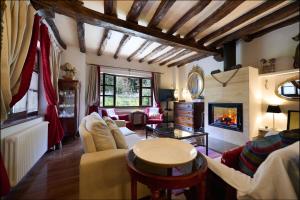 a living room filled with furniture and a fireplace at The Basque Experience by Fidalsa in Ochandiano