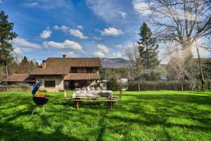 a yard with a bed and a grill in front of a house at The Basque Experience by Fidalsa in Ochandiano