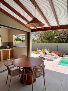 a patio with a table and chairs and a pool at CASA M Peaceful haven with pool in Îlet à Christophe