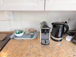 a kitchen counter with a toaster and a coffee maker at LaMer No 5 in Stilbaai