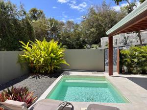 a swimming pool in the middle of a yard at CASA M Peaceful haven with pool in Îlet à Christophe +12 photos