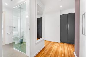 a room with a glass partition with a toilet in it at Adelaide Central Skyline Panoramic Suite Three in Adelaide +21 photos