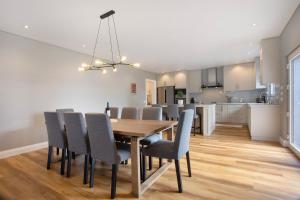 a dining room and kitchen with a table and chairs at Casa D'Avó - Family Coastal Escape in Casa Nova