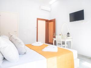 a white bedroom with a bed with a table and a desk at Casa Bella Venezia 1 in Mestre