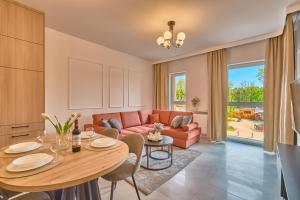 a living room with a table and a couch at Amber Seaside Apartment - Luxury Apartment with Balcony and Parking in Gdansk in Gdańsk