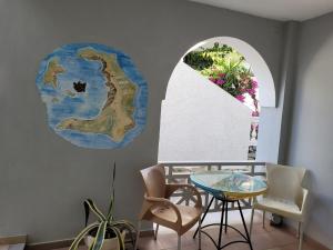 a room with a table and chairs and a window at Rooms By Lignou in Fira