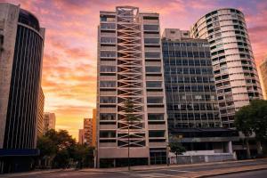 a tall building in a city at sunset at Heritage X in São Paulo
