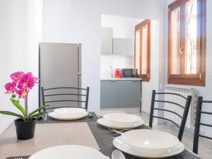 a dining room with a table and chairs and a kitchen at Casa Bella Venezia 1 in Mestre