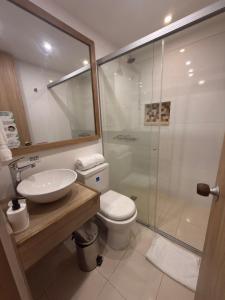 a bathroom with a shower and a toilet and a sink at Hotel Valle de San Nicolas in Rionegro